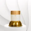 Frasco do HAMI Creme Hidratante da Nutri Bu Alma sobre base dourada decorativa.